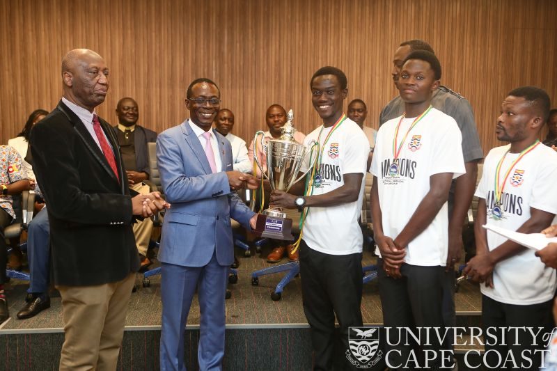 Champions · trophy presented to UCC administration